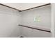 Simple walk-in closet featuring white walls, neutral carpet and wood shelving at 6900 E Princess Dr # 2247, Phoenix, AZ 85054