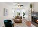 Bright living room with elegant decor, fireplace, and a ceiling fan creating a welcoming atmosphere at 6900 E Princess Dr # 2247, Phoenix, AZ 85054