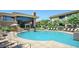 Inviting community pool featuring lounge chairs, seating and a modern waterfall feature at 6900 E Princess Dr # 2247, Phoenix, AZ 85054