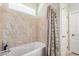 Bathroom featuring a jetted tub with marble-like tile surround and a shower curtain at 726 E Heather Dr, San Tan Valley, AZ 85140
