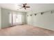 Bright, empty bedroom features neutral carpeting, modern ceiling fan and a bright window providing natural light at 726 E Heather Dr, San Tan Valley, AZ 85140