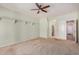 Open, empty bedroom features neutral carpeting, modern ceiling fan, built-in shelving, and an open doorway at 726 E Heather Dr, San Tan Valley, AZ 85140