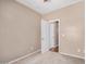 Bedroom with tan walls and carpet with attached bath and closet at 726 E Heather Dr, San Tan Valley, AZ 85140