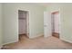 A neutral carpeted bedroom with walk-in closet and an additional doorway at 726 E Heather Dr, San Tan Valley, AZ 85140
