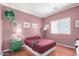 Comfortable bedroom featuring hardwood floors, a window with blinds, and a side table at 726 E Heather Dr, San Tan Valley, AZ 85140
