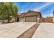 Attractive home with well-manicured landscaping, a three-car garage, and a long private driveway at 726 E Heather Dr, San Tan Valley, AZ 85140