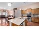 Well-lit kitchen featuring granite countertops, stainless steel appliances, hardwood floors, and a center island at 726 E Heather Dr, San Tan Valley, AZ 85140