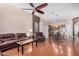 Spacious living room featuring hardwood floors, comfortable seating, a ceiling fan, and an open floor plan at 726 E Heather Dr, San Tan Valley, AZ 85140
