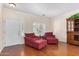 Bright room with hardwood floors, shuttered windows, a hutch, and comfortable armchairs at 726 E Heather Dr, San Tan Valley, AZ 85140