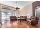 Spacious living room with hardwood floors, ceiling fan, and multiple seating options, offering comfortable and stylish living at 726 E Heather Dr, San Tan Valley, AZ 85140