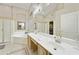 Lovely bathroom features dual sinks, large tub and separate glass enclosed shower at 7262 W Firebird Dr, Glendale, AZ 85308