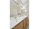 Well-lit bathroom featuring double sinks, ample counter space, and decorative tile accents at 7262 W Firebird Dr, Glendale, AZ 85308