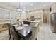 Dining area open to the kitchen with a modern chandelier at 7262 W Firebird Dr, Glendale, AZ 85308