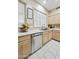 Well-lit kitchen with stainless steel dishwasher and ample counter space at 7262 W Firebird Dr, Glendale, AZ 85308