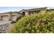 Landscaped front yard featuring vibrant flowering shrubs and rock accents at 7262 W Firebird Dr, Glendale, AZ 85308