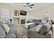 Spacious living room featuring a fireplace, ceiling fan and comfortable gray seating at 7262 W Firebird Dr, Glendale, AZ 85308