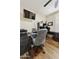 Functional home office featuring hard wood floors, ceiling fan, and lots of desk space at 7262 W Firebird Dr, Glendale, AZ 85308