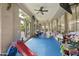 Large playroom features a ceiling fan, lots of games, and lots of natural light at 7262 W Firebird Dr, Glendale, AZ 85308