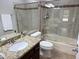 Bathroom with granite countertops and tiled shower at 7272 E Gainey Ranch Rd # 122, Scottsdale, AZ 85258