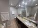 Spacious bathroom with double sinks, granite counters, soaking tub, and tiled shower enclosure at 7272 E Gainey Ranch Rd # 122, Scottsdale, AZ 85258