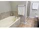 Inviting soaking tub with tiled surround, offering a tranquil space for relaxation and rejuvenation at 7272 E Gainey Ranch Rd # 122, Scottsdale, AZ 85258