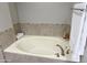 Cozy bathtub with tiled accents, providing a comfortable and stylish space for unwinding after a long day at 7272 E Gainey Ranch Rd # 122, Scottsdale, AZ 85258