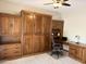 Bedroom with carpet and built-in Murphy bed and desk at 7272 E Gainey Ranch Rd # 122, Scottsdale, AZ 85258