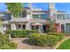 Exterior view of a well-maintained home with lush landscaping and a charming patio area at 7272 E Gainey Ranch Rd # 122, Scottsdale, AZ 85258