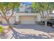 Exterior shot of a home with a three-car garage and a well-kept driveway at 7272 E Gainey Ranch Rd # 122, Scottsdale, AZ 85258