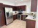 Spacious kitchen with stainless steel appliances and dark cabinets at 7272 E Gainey Ranch Rd # 122, Scottsdale, AZ 85258