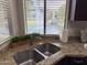 Kitchen sink with granite countertops and view of pond at 7272 E Gainey Ranch Rd # 122, Scottsdale, AZ 85258