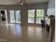 Bright living room with tile flooring, access to the kitchen, and views of the patio and water feature at 7272 E Gainey Ranch Rd # 122, Scottsdale, AZ 85258