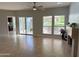 Bright living room featuring tile floors, access to the kitchen, and views of the outdoor patio and landscaping at 7272 E Gainey Ranch Rd # 122, Scottsdale, AZ 85258