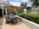 Picturesque patio with outdoor seating and views of a serene pond, fountain, and lush landscaping creating a tranquil retreat at 7272 E Gainey Ranch Rd # 122, Scottsdale, AZ 85258