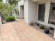 Private patio adorned with potted plants and tiled flooring, creating a serene outdoor retreat at 7272 E Gainey Ranch Rd # 122, Scottsdale, AZ 85258