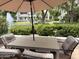 Charming patio area with outdoor dining set, perfect for enjoying meals amidst scenic views of the community pond at 7272 E Gainey Ranch Rd # 122, Scottsdale, AZ 85258