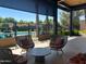 Relaxing covered patio with wicker seating offers views of the community pool at 7272 E Gainey Ranch Rd # 122, Scottsdale, AZ 85258