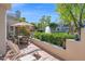 Relaxing patio space with lounge chairs, an umbrella-covered table, and views of the water feature at 7272 E Gainey Ranch Rd # 122, Scottsdale, AZ 85258
