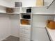 Organized walk-in closet with custom shelving and ample storage space for clothing and accessories at 7272 E Gainey Ranch Rd # 122, Scottsdale, AZ 85258