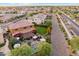 Birds eye view of backyard oasis featuring a sparkling pool, covered patio, and lush landscaping at 7503 S Roanoke St, Gilbert, AZ 85298