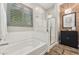 Stylish bathroom featuring a soaking tub, glass-enclosed shower, and modern fixtures at 7503 S Roanoke St, Gilbert, AZ 85298