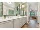 Well-lit bathroom features a dual sink vanity with eye-catching tile and view to the main bedroom at 7503 S Roanoke St, Gilbert, AZ 85298