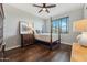 Relaxing bedroom with a four poster bed and dark hardwood floors at 7503 S Roanoke St, Gilbert, AZ 85298