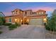 Beautiful two-story home featuring a three-car garage, desert landscaping, and a charming stone facade at 7503 S Roanoke St, Gilbert, AZ 85298