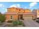 Stunning two-story home with a well-manicured front yard, paver driveway, three-car garage, and charming curb appeal at 7503 S Roanoke St, Gilbert, AZ 85298