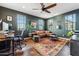 Comfortable home office with dark green walls, natural lighting, and ample desk space at 7503 S Roanoke St, Gilbert, AZ 85298