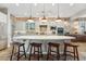 Bright, open kitchen boasts a large center island with bar seating, stone accent wall, and modern lighting at 7503 S Roanoke St, Gilbert, AZ 85298