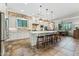 Open concept kitchen with a large island, pendant lights, and seamless flow into the adjacent dining area at 7503 S Roanoke St, Gilbert, AZ 85298