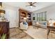 Comfortable living room featuring a cozy couch, decorative bookshelf, and a calming atmosphere with natural light at 7503 S Roanoke St, Gilbert, AZ 85298