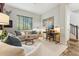 Stylish living room featuring comfortable seating, a modern desk, and ample natural light from large windows at 7503 S Roanoke St, Gilbert, AZ 85298